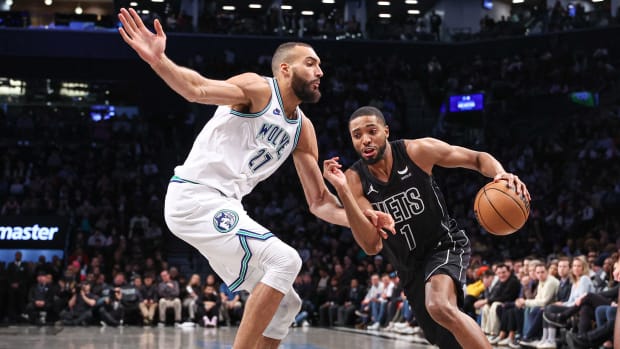 Nets' Mikal Bridges drives on Wolves' Rudy Gobert